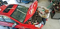 PTAC employee repairing a car